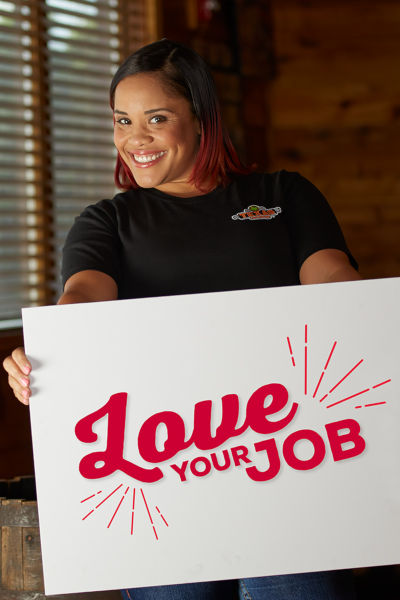 Employee with love your job sign